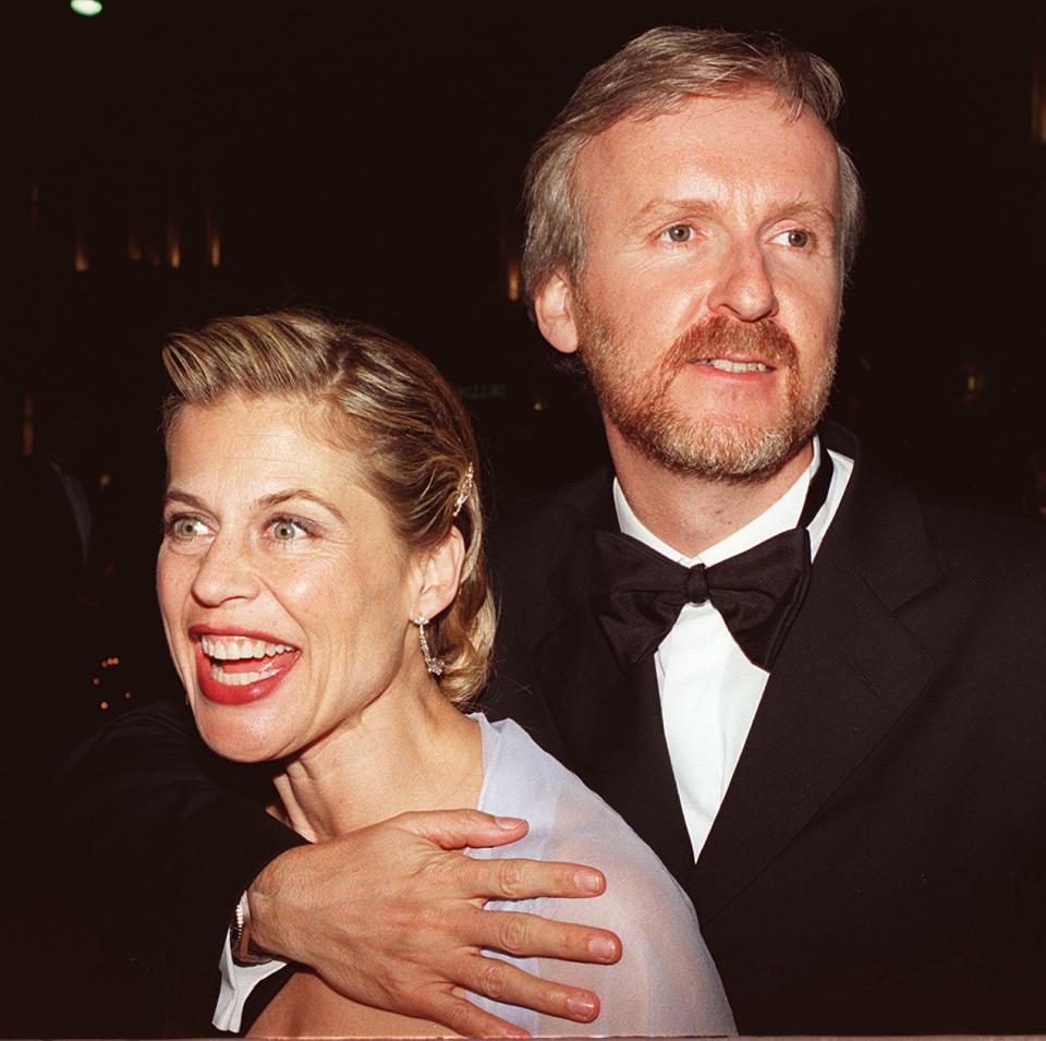 LOS ANGELES, UNITED STATES:  Titanic Director James Cameron celebrates with wife Linda Hamilton 24 March at the Titanic party in Los Angeles after the film won 11 Academy Awards.         AFP PHOTO  LUCY NICHOLSON (Photo credit should read LUCY NICHOLSON/AFP via Getty Images)