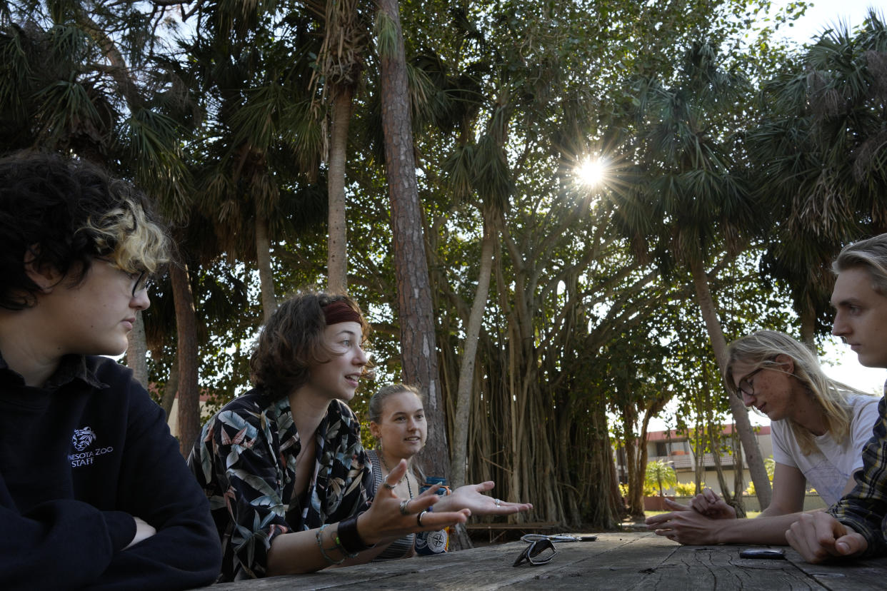 New College of Florida students, from left, Niko Jackson, Viv Cargille, Olivia Pare, Willem Aspinall, and Riley Wood, discuss how changes to the school are affecting their college experience, during a meeting with Associated Press journalists on the New College of Florida campus, Thursday, March 2, 2023, in Sarasota, Fla. "I'm sorry, but this isn't an indoctrination facility. This isn't a factory that pumps out, you know, non-binary communists," says Cargille, 20, a marine biology major from Miami. She is passionate about researching dolphin acoustics, but finds it mentally exhausting to focus on classes in a climate she describes as turbulent, volatile and anxiety-inducing.(AP Photo/Rebecca Blackwell)