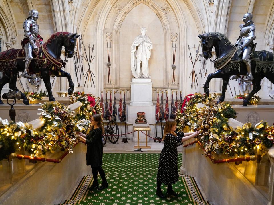 Members of the Royal Collection Trust decorate the Grand Staircase.