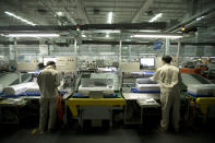 In this Friday, Feb. 24, 2017 photo, factory workers assemble air conditioners on an assembly line at a Haier factory in Jiaozhou near Qingdao in eastern China's Shandong Province. Zhang Ruimin built Haier from a failing refrigerator factory in the 1980s into the biggest maker of major appliances. Now, he is trying to transform a traditional manufacturer with 60,000 employees in 25 countries into a nimble, Internet Age seller of consumer goods and services from web-linked washing machines to food delivery. (AP Photo/Mark Schiefelbein)