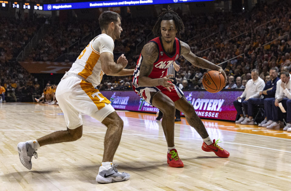 Mississippi guard Allen Flanigan (7) works for a shot as he's defended by Tennessee guard Santiago Vescovi (25) during the second half of an NCAA college basketball game Saturday, Jan. 6, 2024, in Knoxville, Tenn. (AP Photo/Wade Payne)