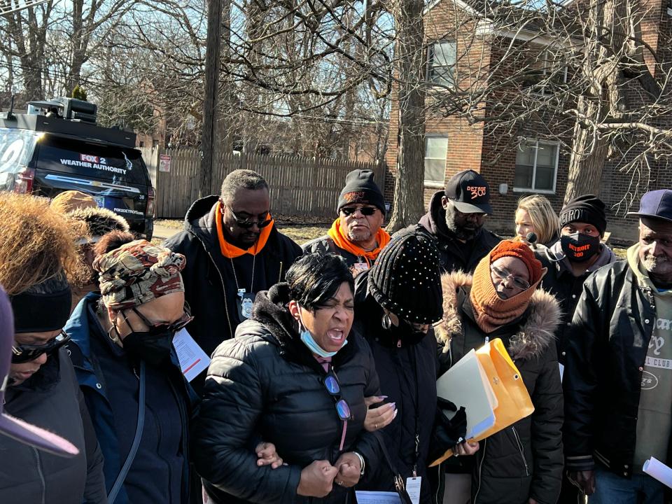 A woman praying as Detroiters gathered on March 29, 2023 at the intersection of Memorial Street and Glendale Street to raise awareness about a sexual assault of an 80-year-old woman outside her home on Memorial Street just days prior. The suspect was still at large.