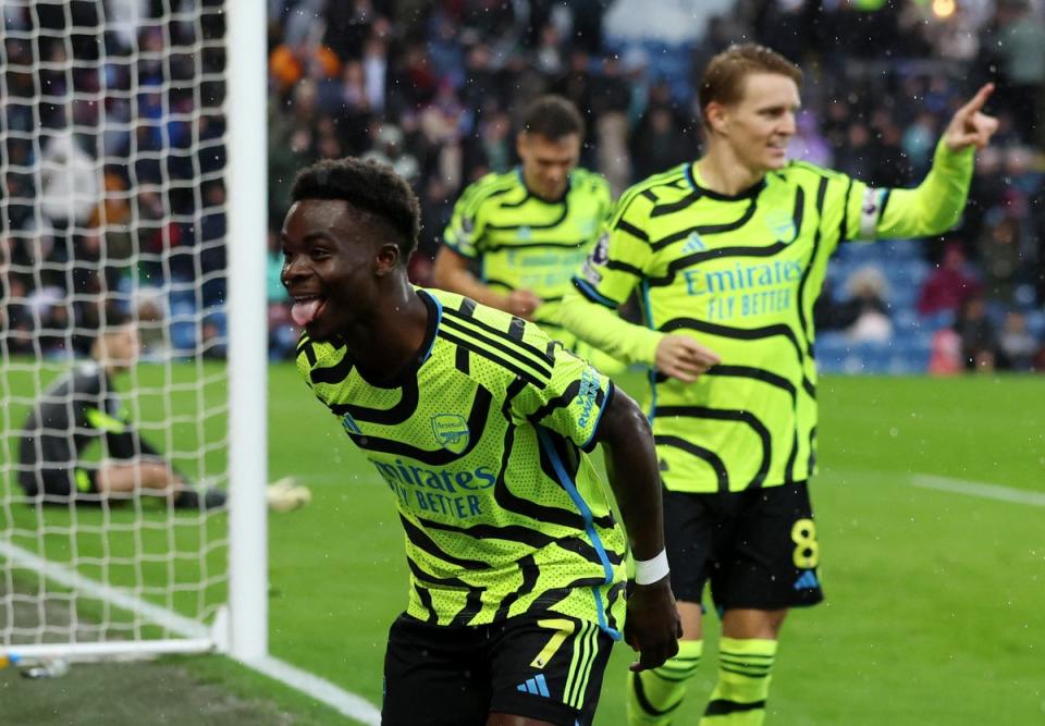 Bukayo Saka celebrates scoring Arsenal’s third, set up by Odegaard (Reuters)