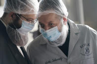 Rabbis Joseph Schwartz, right, and Mendel Einhorn confer as they supervise Hanan Products preparations for their kosher-for-passover production run, Thursday, Jan. 7, 2021, in Hicksville, N.Y. The rabbis are tasked with ensuring that the production line and foods made here meet the strict kosher requirements of Passover. (AP Photo/Seth Wenig)