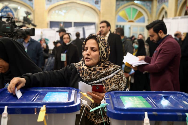 Woman casts her vote during parliamentary elections at a polling station in Tehran