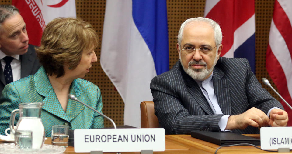 European Union foreign policy chief Catherine Ashton, left, and Iranian Foreign Minister Mohamad Javad Zarif, right, wait for the start of closed-door nuclear talks in Vienna, Austria, Tuesday, March 18, 2014. Ashton and Zarif have launched a new round of nuclear talks between Tehran and six world powers, putting a reported tiff behind them. The two sides hope to reach an agreement by July that trims Iran's nuclear activities in exchange for an end to sanctions choking Tehran's economy. (AP Photo/Ronald Zak)