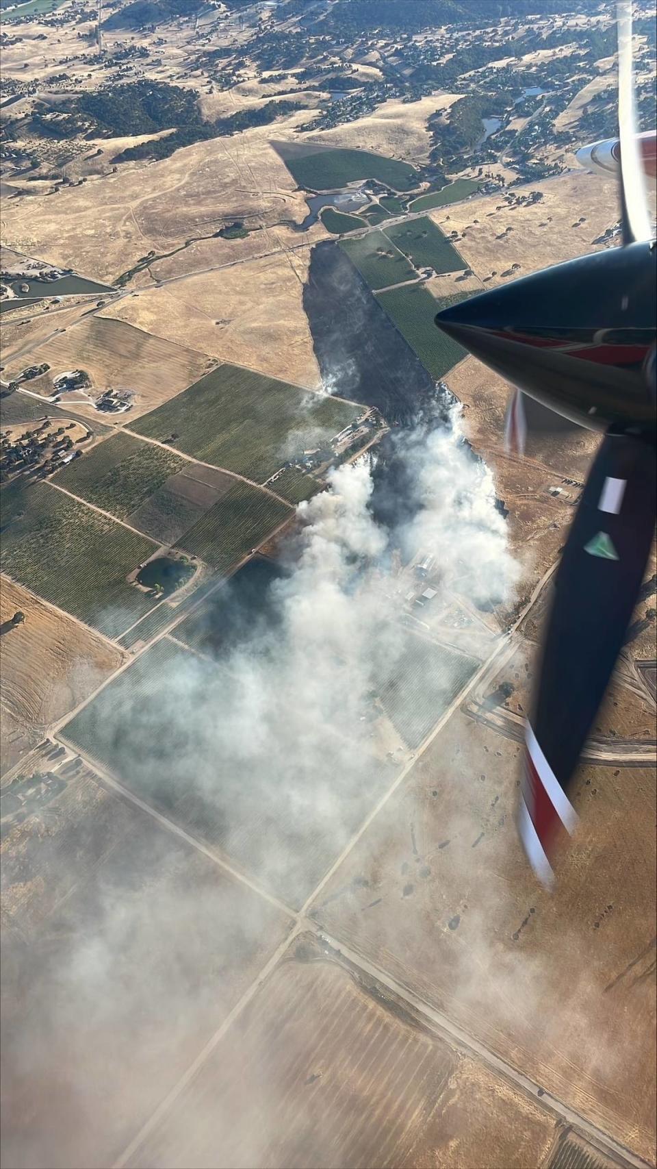 A fire burns vegetation off Creston Road in Paso Robles on Monday, July 8, 2024.