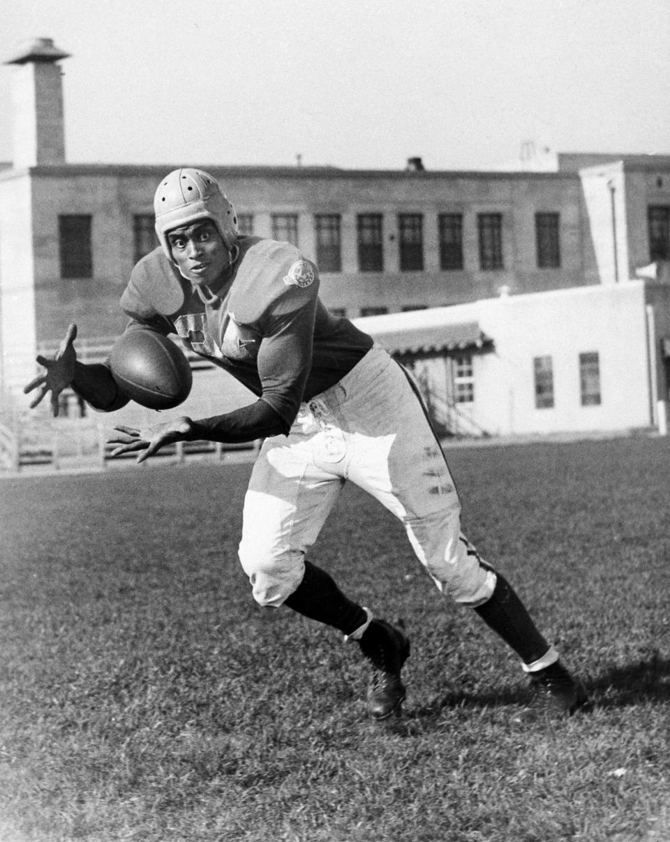 Los Angeles Rams end Woody Strode catches a football in a 1946 game. Strode overcame prejudice in pro football and then had a productive career acting in Hollywood action films.