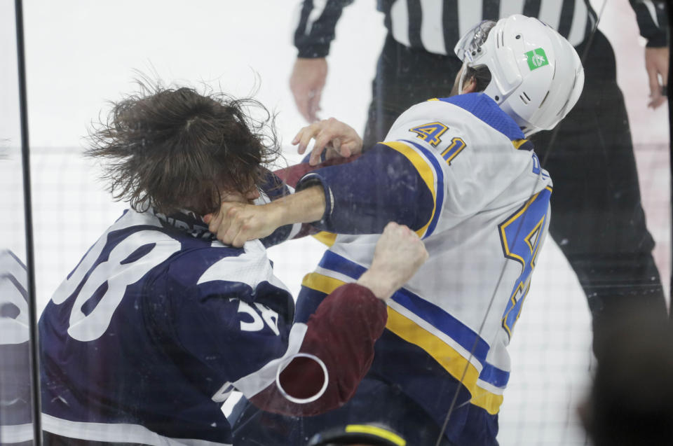 Colorado Avalanche center Liam O'Brien, left, fights St. Louis Blues defenseman Robert Bortuzzo (41) during the second period of an NHL hockey game in Denver, Saturday, April 3, 2021. (AP Photo/Joe Mahoney)