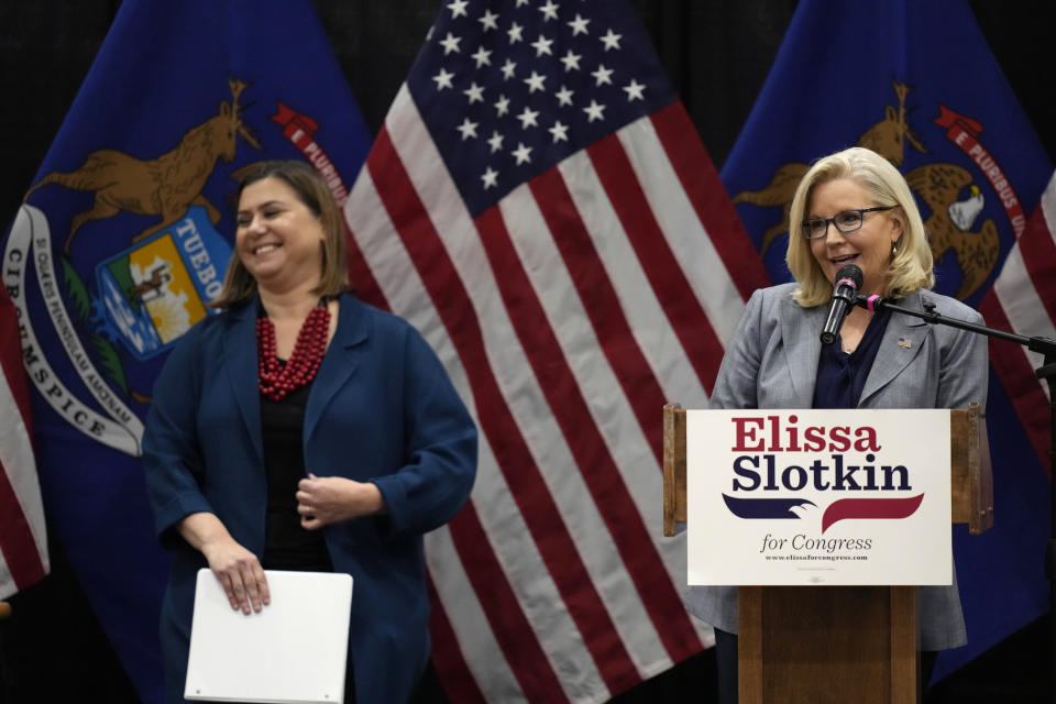 U.S. Rep. Elissa Slotkin, D-Mich., smiles as Rep. Liz Cheney, R-Wyo., offers her support during a campaign rally, Tuesday, Nov. 1, 2022, in East Lansing, Mich. Slotkin emphasized how a shared concern for a functioning democracy can unite Democrats and Republicans despite policy disagreements. (AP Photo/Carlos Osorio)