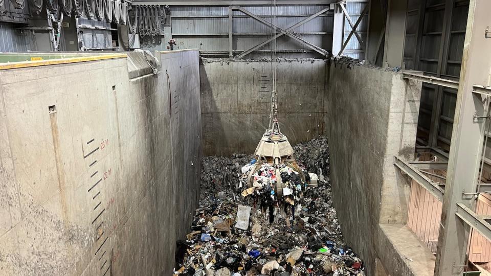 A grapple with metal arms grabs a pile of garbage from a containment room at the Durham York Energy Centre. One load is sent to the boilers every 15 minutes. 