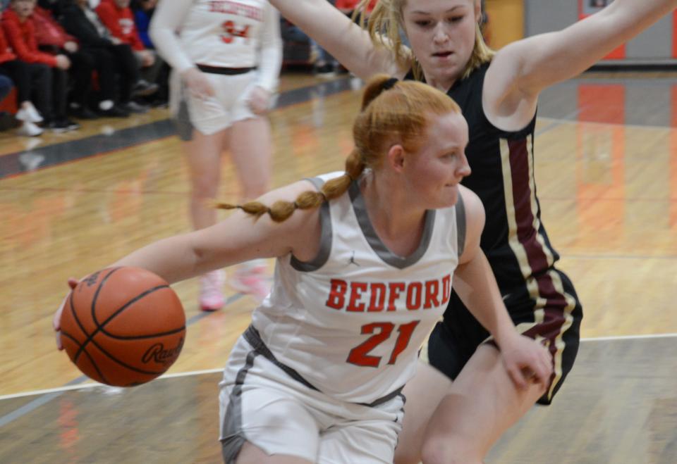 Aubrey Hensley of Bedford gets cut off on the baseline by Dexter's Heidi Fuchs Friday night.