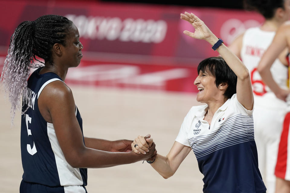 France head coach Valerie Garnier celebrates with Endene Miyem, left, after a women's basketball quarterfinal round game against Spain at the 2020 Summer Olympics, Wednesday, Aug. 4, 2021, in Saitama, Japan. (AP Photo/Charlie Neibergall)