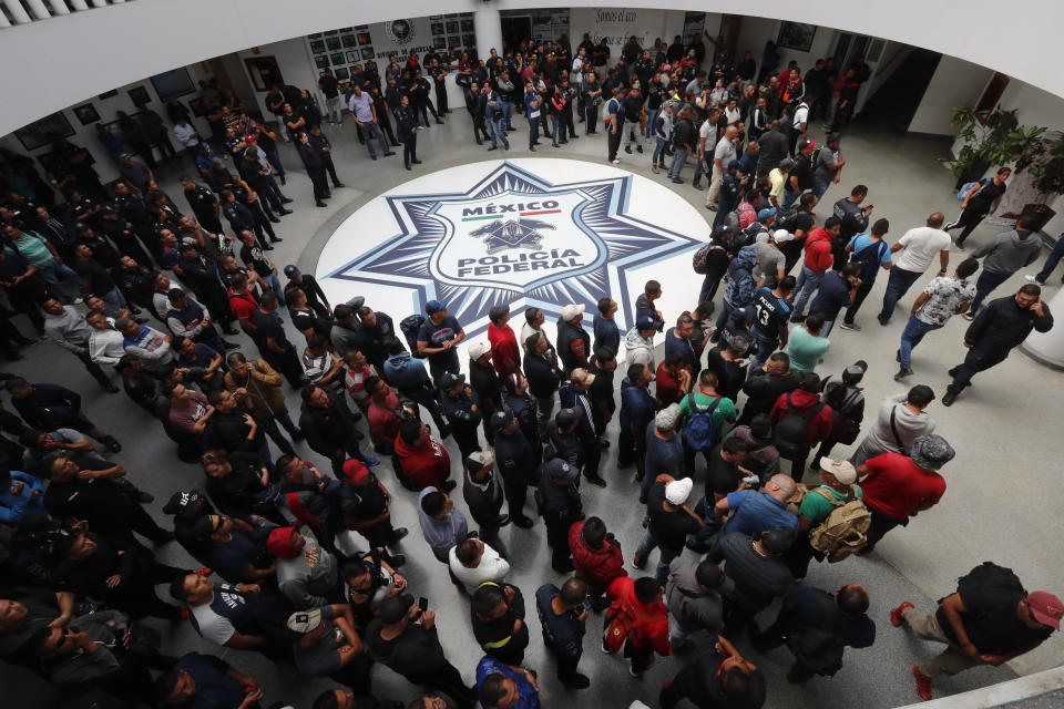 Dozens of Mexican federal police gather at a police command center in the Iztapalapa borough, in Mexico City, Wednesday, July 3, 2019, to protest against plans to force them into the newly formed National Guard. The protest comes as the government is officially starting to deploy the National Guard to several states to fight crime and control immigration. (AP Photo/Marco Ugarte)