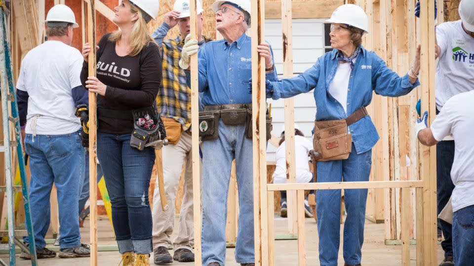 Trisha Yearwood helps the Carters raise the walls of a new Habitat home in Memphis Tennessee in 2015.  - Ezra Millstein