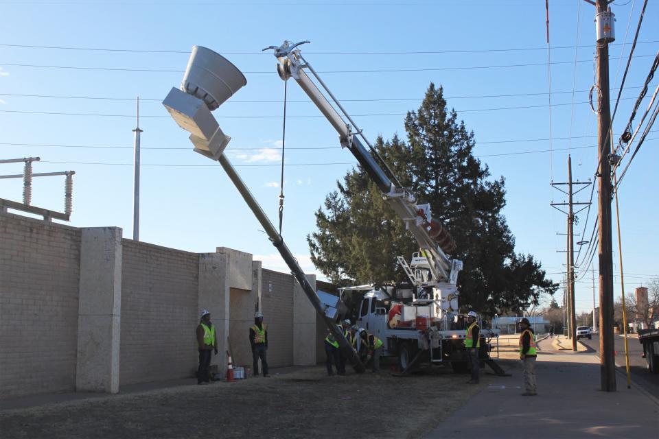 A crew from Lubbock Power & Light works to raise the city's newest tornado siren on Tuesday morning at 30th Street and Elgin Avenue. This is the 16th of 45 sirens the City of Lubbock plans to install.