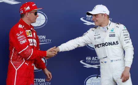 Formula One - F1 - Azerbaijan Grand Prix - Baku, Azerbaijan - June 24, 2017. Ferrari's Kimi Raikkonen of Finland greets Mercedes' Valtteri Bottas of Finland after the qualifying session. REUTERS/David Mdzinarishvili