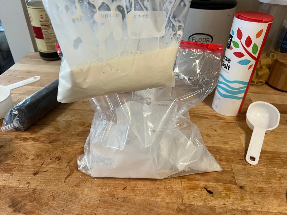 Bag filled with ice-cream ingredients and bigger bag filled with salt and water