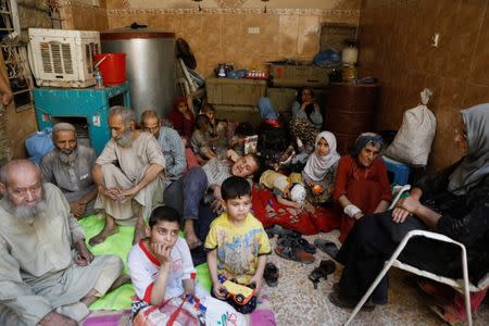 Displaced Iraqi civilians rescued at the site of battle rest at the positions of Iraqi forces at the Old City in Mosul, Iraq June 29, 2017. REUTERS/Erik De Castro