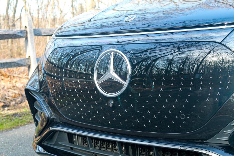 The 2023 Mercedes-Benz EQS SUV's front badge and grille area shown up close with lots of tiny Mercedes stars.