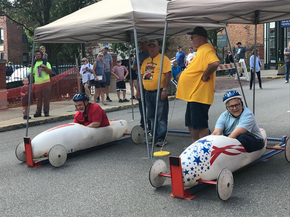 Former Mansfield Mayor Tim Theaker, right, and Lucas Mayor Todd Hall competed in a celebrity race at the 2022 North Central Soap Box Derby in downtown Mansfield. Theaker, competing for his ninth year, won the race.
