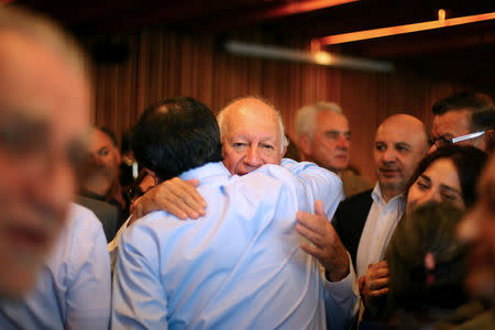 Former Chile's president and center-left presidential candidate Ricardo Lagos (C) is hugged after dropping out his presidential campaign, in Santiago, April 10, 2017. REUTERS/Ivan Alvarado