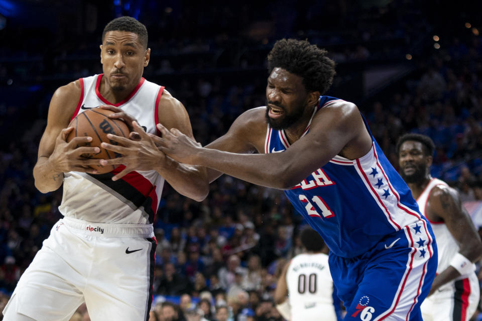 Portland Trail Blazers' Malcolm Brogdon, left, steals the ball from Philadelphia 76ers' Joel Embiid, right, during the first half of an NBA basketball game, Sunday, Oct. 29, 2023, in Philadelphia. (AP Photo/Chris Szagola)