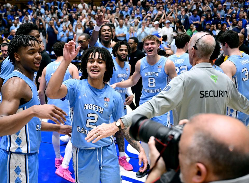 The North Carolina Tar Heels wave goodbye to Duke fans as they leave the court at Cameron Indoor Stadium.