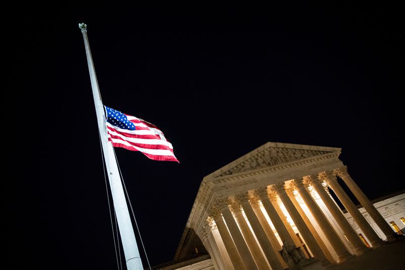 The American flag flies at half staff following the death of U.S. Supreme Court Justice Ruth Bader Ginsburg, outside of the U.S. Supreme Court, in Washington