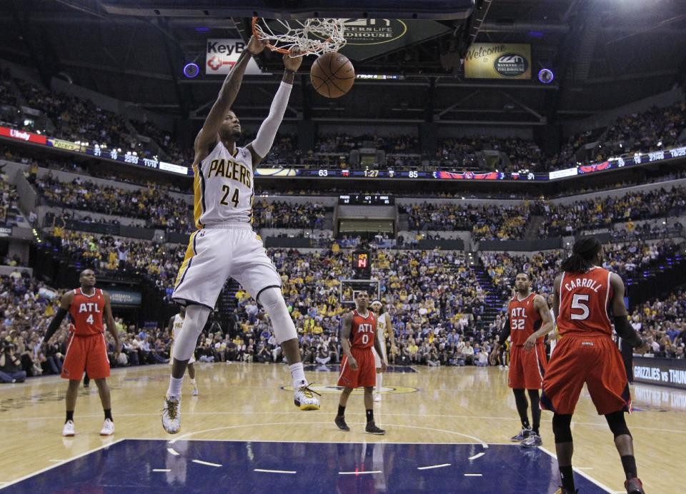 Indiana Pacers' Paul George (24) dunks during the second half in Game 5 of an opening-round NBA basketball playoff series against the Atlanta Hawks Monday, April 28, 2014, in Indianapolis. Atlanta defeated Indiana 107-97. (AP Photo/Darron Cummings)