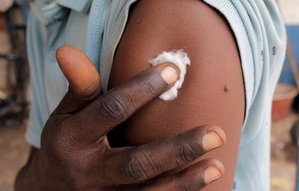 A Bundung garage driver holds his arm after being vaccinated during a mobile vaccination campaign against COVID-19 in Banjul, Gambia May 11, 2022. Picture taken May 11, 2022. REUTERS/Ngouda Dione