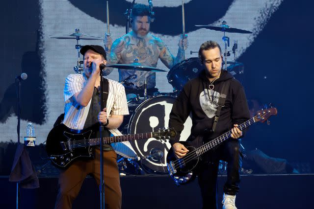 <p>Kevin Winter/Getty</p> (L-R) Patrick Stump, Andy Hurley and Pete Wentz of Fall Out Boy performing in Inglewood in January 2023