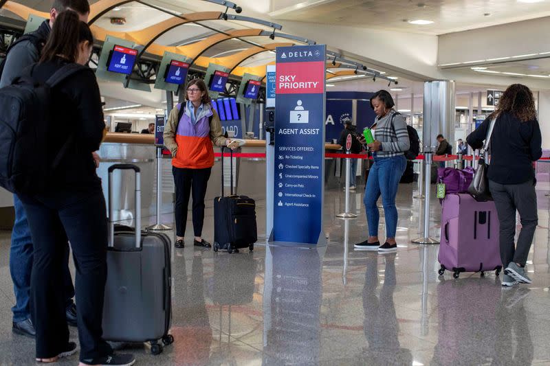 FILE PHOTO: Passengers wait for the flights to resume at Hartsfield-Jackson Atlanta International Airport in Atlanta