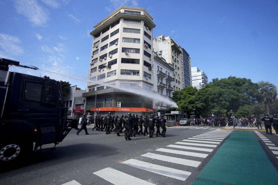 Police use water to disperse an anti-government protest against food scarcity at soup kitchens and against economic reforms proposed by President Javier Milei in Buenos Aires, Argentina, Wednesday, April 10, 2024. (AP Photo/Natacha Pisarenko)