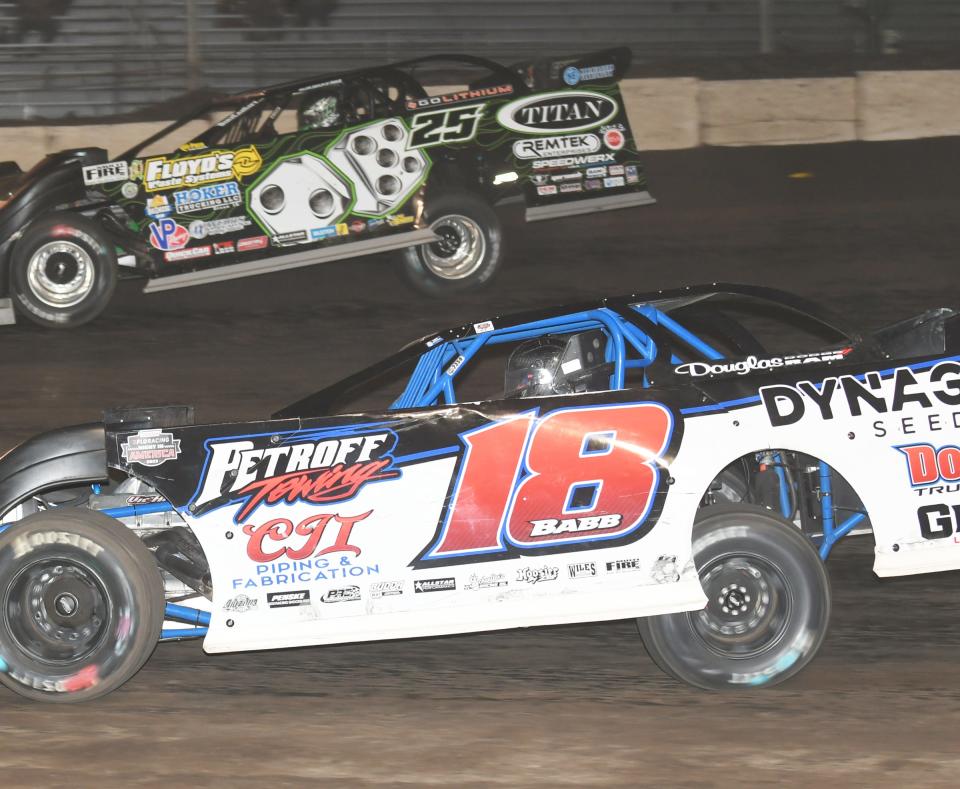 Shannon Babb (18) and Jason Feger (25) battle for the lead in the MARS late model feature race Saturday at Fairbury Speedway. In the end, it was Feger prevailing.