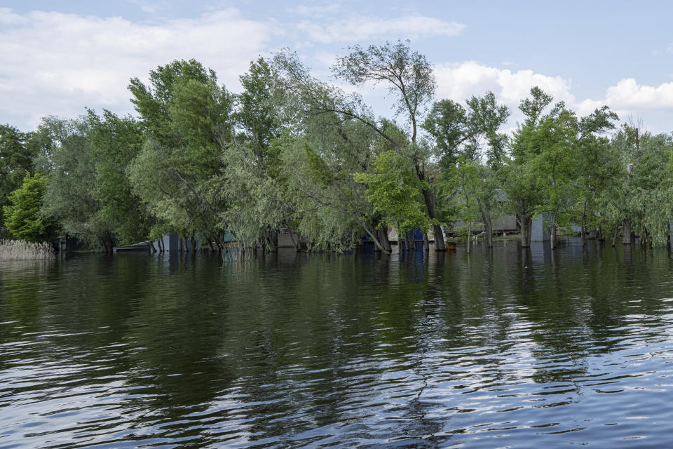 Flooded houses are seen in the island at reservoir on Dnipro river near Lysohirka, Ukraine, Thursday, May 18, 2023. Damage that has gone unrepaired for months at a Russian-occupied dam is causing dangerously high water levels along a reservoir in southern Ukraine. (AP Photo/Evgeniy Maloletka)