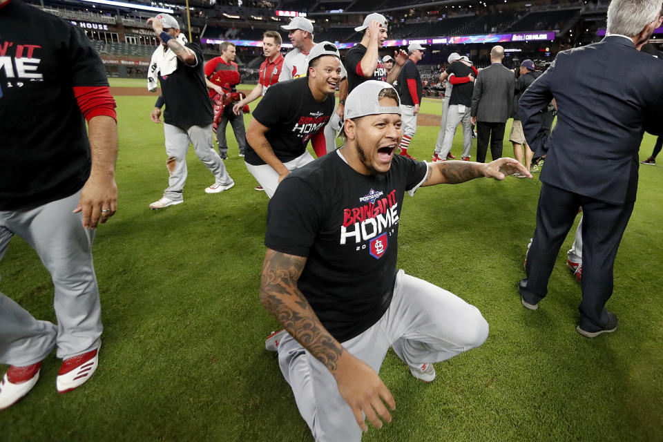 St. Louis Cardinals relief pitcher Carlos Martinez, center, celebrates with teammates after the Cardinals beat the Atlanta Braves 13-1 in Game 5 of their National League Division Series baseball game Wednesday, Oct. 9, 2019, in Atlanta. (AP Photo/John Bazemore)