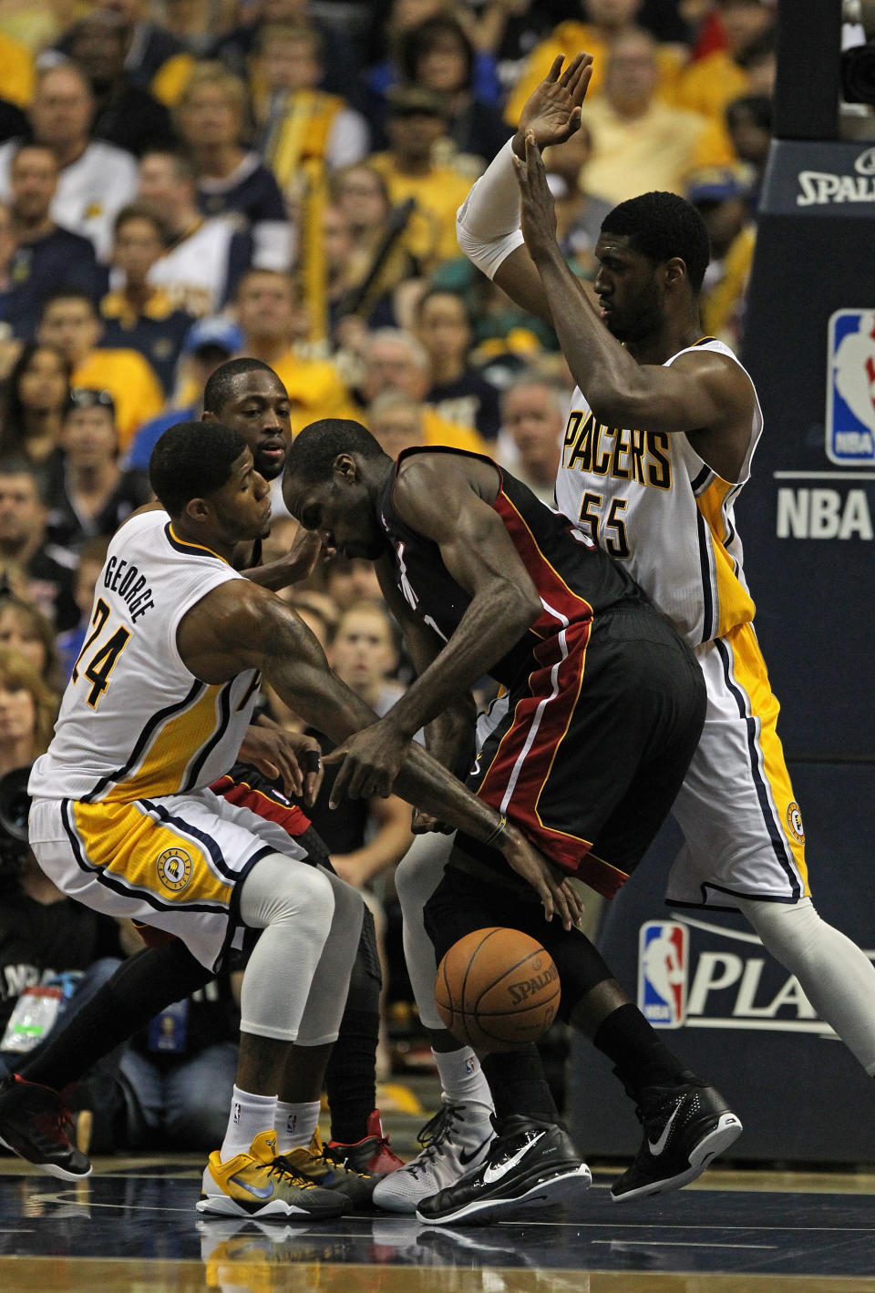 INDIANAPOLIS, IN - MAY 20: Paul George #24 of the Indiana Pacers knocks the ball away from Joel Anthony #50 of the Miami Heat as Roy Hibbert #55 defends in Game Four of the Eastern Conference Semifinals in the 2012 NBA Playoffs at Bankers Life Fieldhouse on May 20, 2012 in Indianapolis, Indiana. NOTE TO USER: User expressly acknowledges and agrees that, by downloading and/or using this photograph, User is consenting to the terms and conditions of the Getty Images License Agreement. (Photo by Jonathan Daniel/Getty Images)