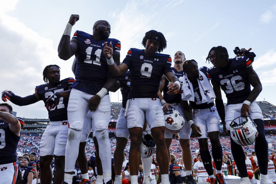 Auburn quarterback Robby Ashford (9) celebrates with teammates after Auburn defeated Massachusetts in an NCAA college football game, Saturday, Sept. 2, 2023, in Auburn, Ala. (AP Photo/Butch Dill)