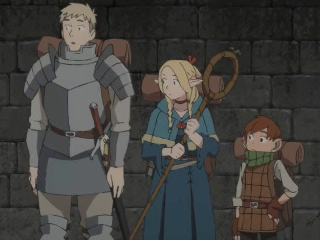 a knight, mage, and young boy stand together in a stone hallway