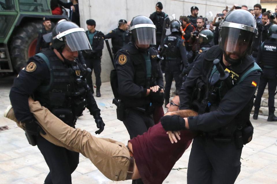 Spanish police drag man outside polling station in 2017Getty