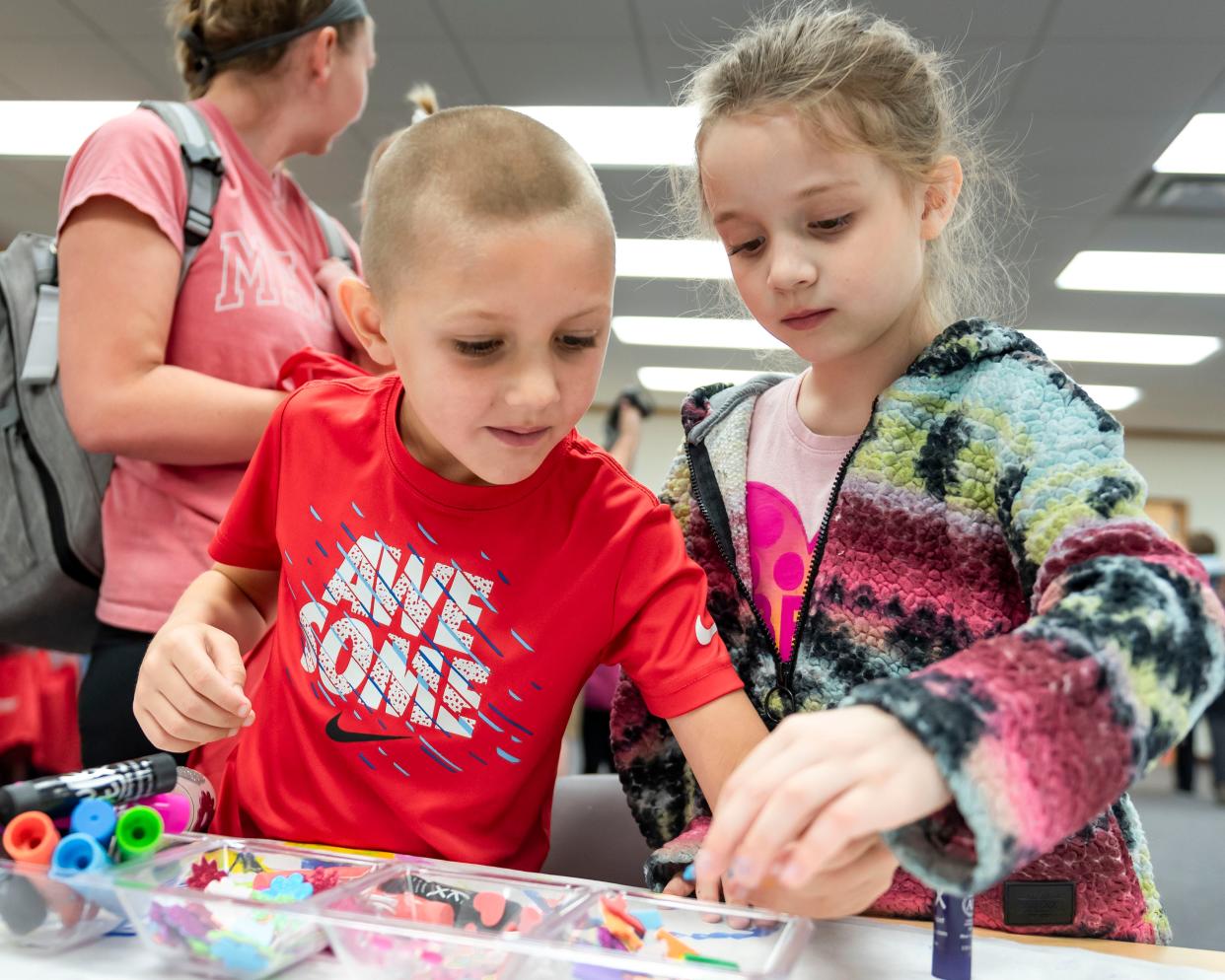 Ronan Scharf (left) and Freya Dodd decorate telescopes during the Earth Plus Expo, presented by Earth Week Plus, at the Cheboygan Area Public Library on Saturday, April 20, 2024.