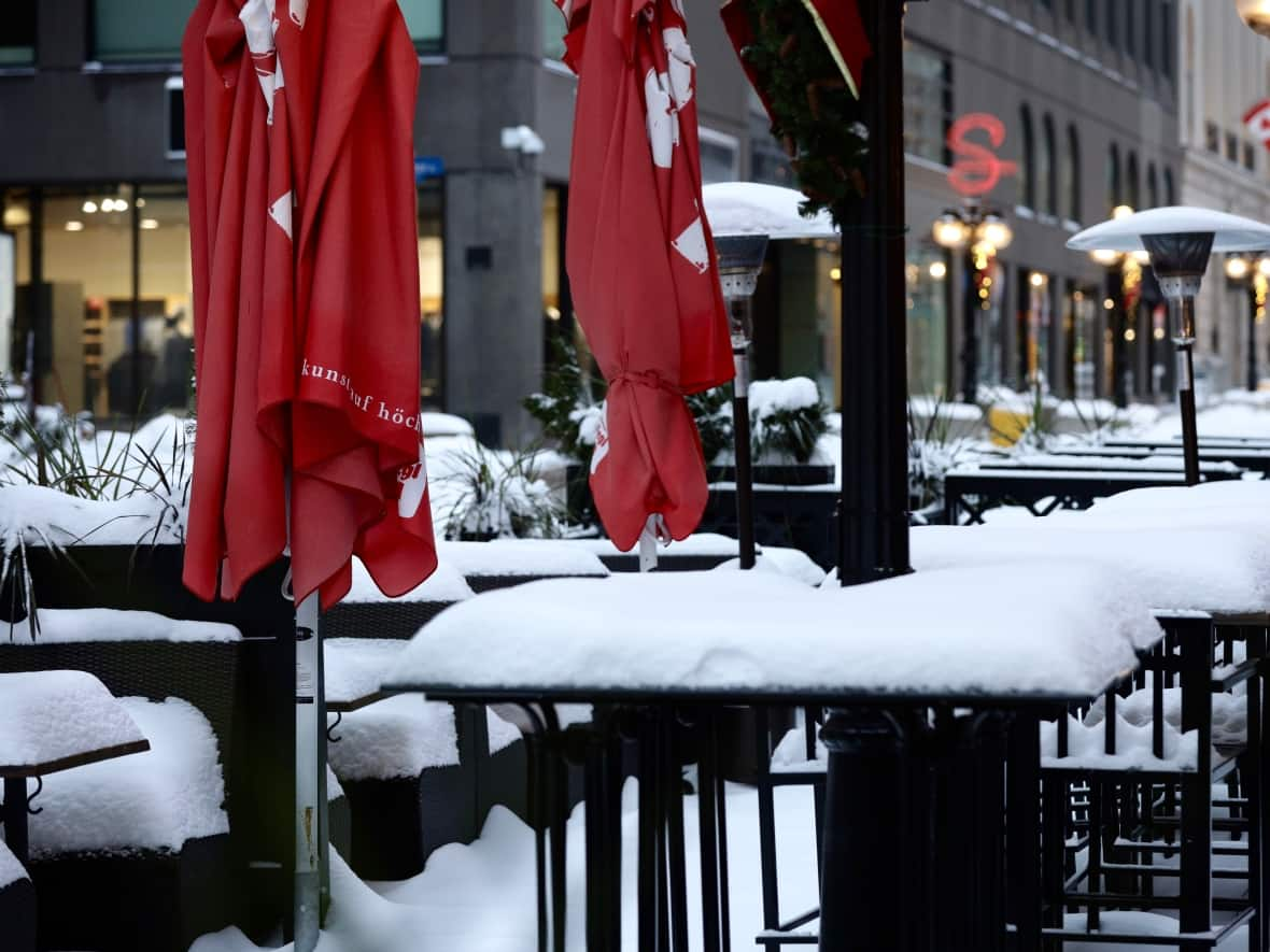 A patio covered in snow on Sparks Street in Ottawa Nov. 26, 2020, during one of the multiple bans on dine-in service across Ontario during the COVID-19 pandemic. (Andrew Lee/CBC - image credit)