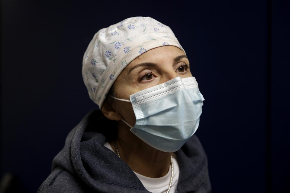 Nurse Cristina Settembrese talks during an interview with the Associated Press outside the intensive care unit after finishing a night shift, at the San Paolo hospital, in Milan, Italy, Thursday, Oct. 15, 2020. (AP Photo/Luca Bruno)