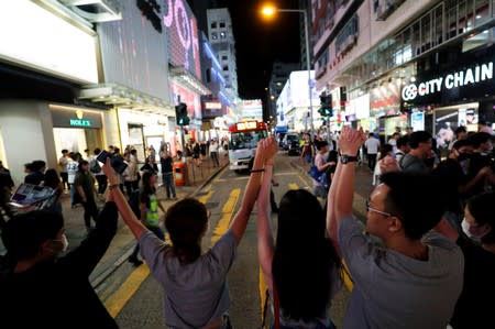 Protesters hold hands to form a human chain during a rally to call for political reforms at Mongkok district in Hong Kong