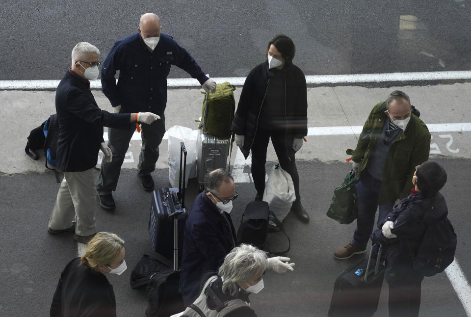 Members of a WHO team arrives in Wuhan in central China's Hubei province on Thursday, Jan. 14, 2021. The global team of researchers arrived Thursday in the Chinese city where the coronavirus pandemic was first detected to conduct a politically sensitive investigation into its origins amid uncertainty about whether Beijing might try to prevent embarrassing discoveries. (AP Photo/Ng Han Guan)