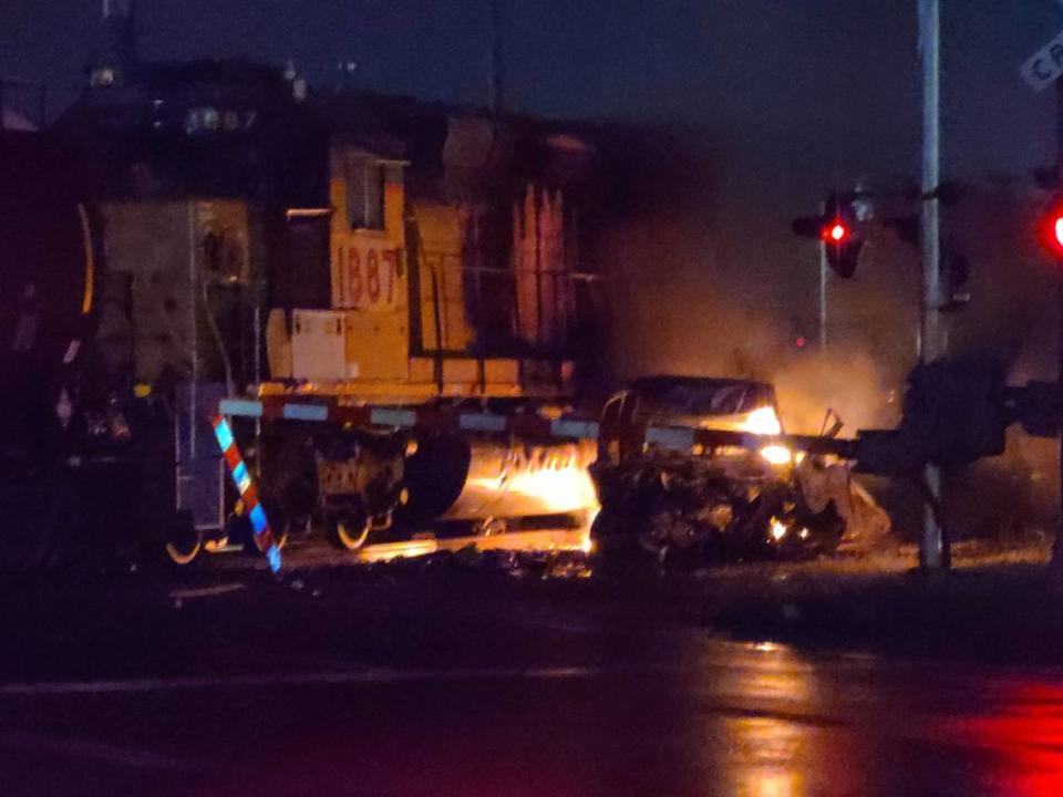 A pickup truck and one of two engines of a Union Pacific train burn after a crash at a railroad crossing early Saturday morning on Mississippi Avenue in Sauget. The truck driver was killed.
