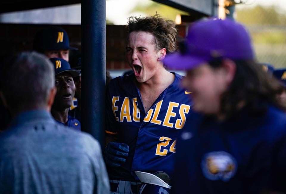Naples Golden Eagles pitcher Reilly Witmer (24) celebrates in the dugout after hitting a home run during the first inning of the Class 5A District 12 championship against the Barron Collier Cougars at Naples High School on Thursday, May 4, 2023.