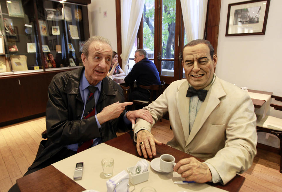 Lorenzo Pepe, director of the Juan Peron institute, gestures as he sits next to a statue of former Argentine President Juan Peron at the "Un cafe con Peron" (A coffee with Peron) restaurant in Buenos Aires May 8, 2011. REUTERS/Marcos Brindicci