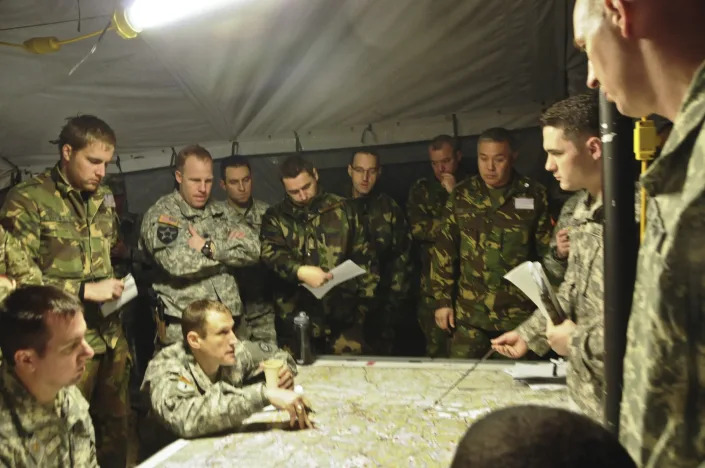 Leaders assigned to 2nd Cavalry Regiment conduct a multinational war gaming meeting involving leaders from the United Kingdom, Hungary and the Netherlands during a planning phase while participating in Allied Spirit I at Hohenfels Training Area located in Germany, Jan. 20, 2015. (Army)